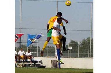 Guyana’s Les Charles Critchelow St Lucia’s Dujon Verneige goes airborne to battle for a loose ball.