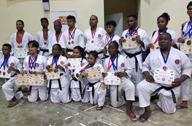 The winning karatekas display their prizes.