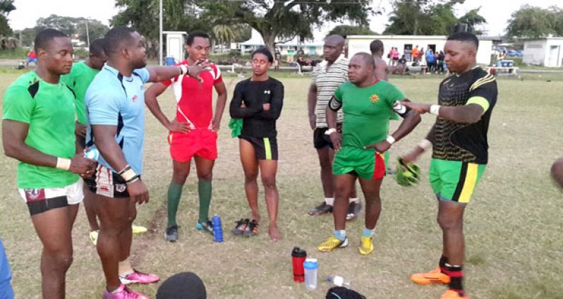 Kevin McKenzie (second from left) makes a point during training at the National Park.