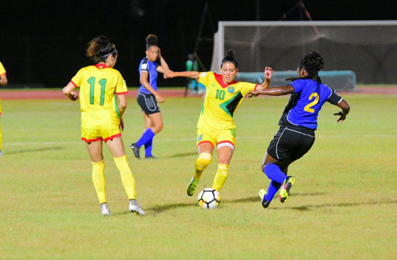 Guyana’s Mariam El-Masri (10) and Calaigh Copland (11) trying to make a move on the ‘Bajan’ defence during their scoreless draw at the Leonora Track and Field Centre. (Samuel Maughn photo)