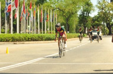 Guyana’s Kravitz Jeffery crossing the finish line while his teammates (Shaquel Agard, Alanzo Ambrose and Akeem Arthur) celebrate in the back ground