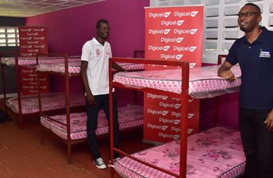 Digicel’s Head of Customer Care, Sherwin Osbourne (left), and Director of Sport, Christopher Jones, near some of the beds equipped with new mattresses