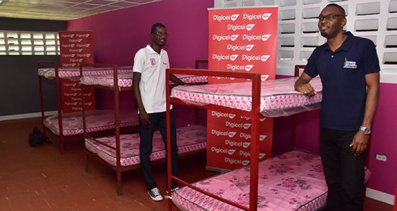 Digicel’s Head of Customer Care, Sherwin Osbourne (left), and Director of Sport, Christopher Jones, near some of the beds equipped with new mattresses