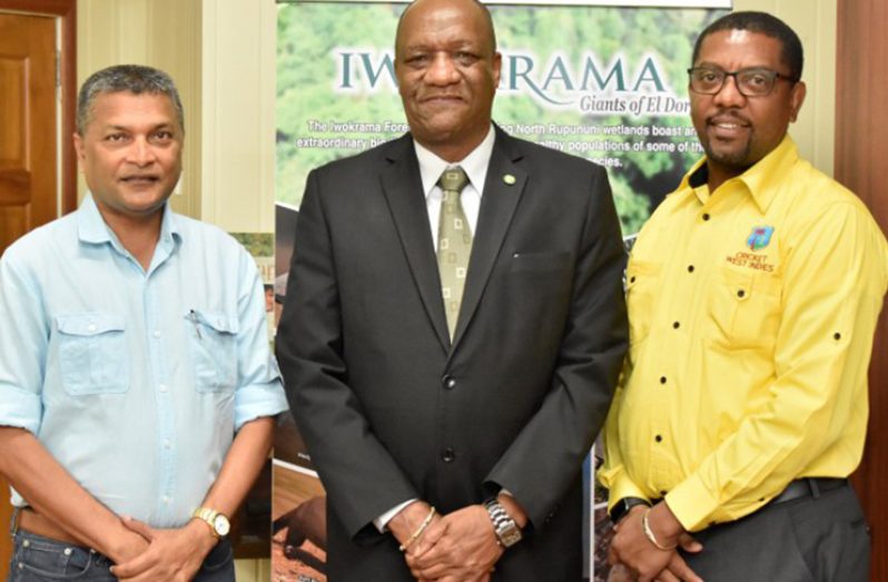 Minister Joseph Harmon is flanked by Dave Cameron (right) and Anand Sanasie.