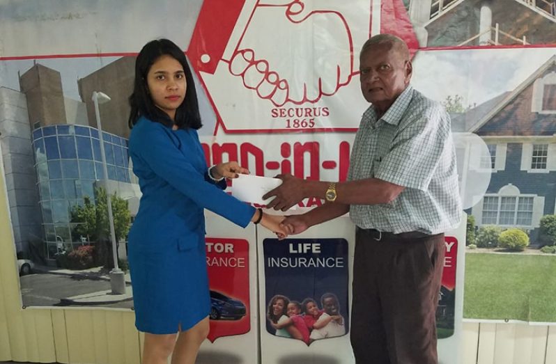 Business Development personnel at Hand-in-Hand Mutual Fire and Life Insurance, Soma Bharrat, hands over the sponsorship package to organiser, Hassan Mohamed.
