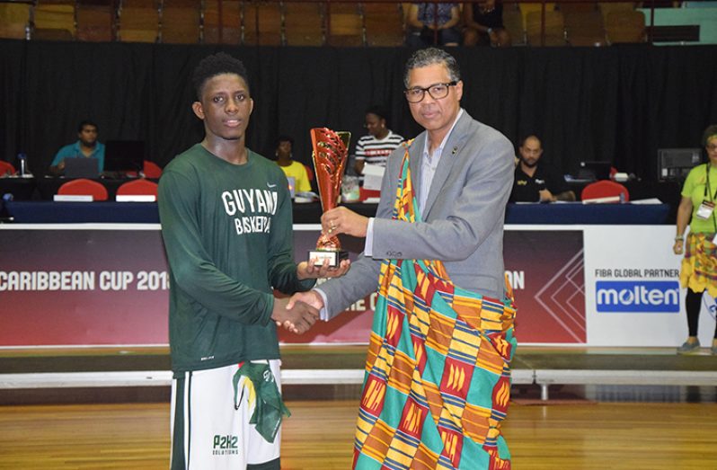 FLASHBACK! Patrick Haynes (right) hands over the CBC Championship Most Valuable Player (MVP) award to Guyana’s Stanton Rose, following the completion of the tournament in Suriname in 2018.