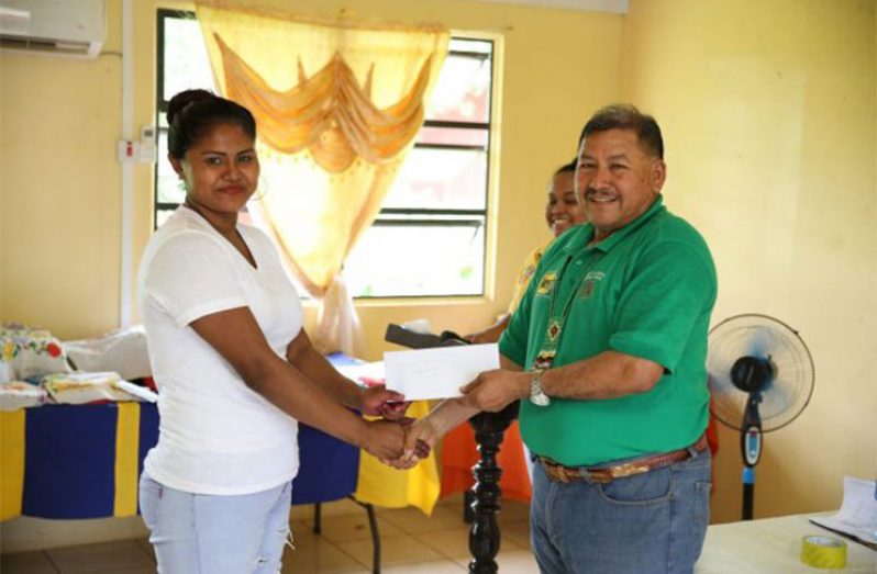 Emma Williams of Canal Bank receiving her grant from Minister of Indigenous
Peoples’ Affairs, Hon. Sydney Allicock