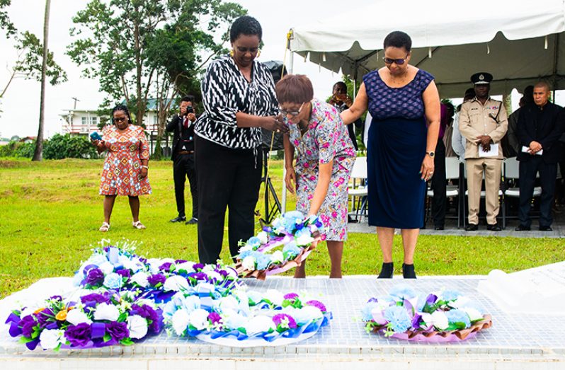 PNC Chairman and Minister of Public Health, Volda Lawrence (right), assists President Hoyte’s sister Gloria Hoyte to lay a floral tribute at the tomb (Samuel Maughn photo)