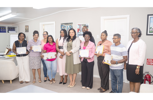 HSM Minister of Human Services and Social Security, Dr. Vindhya Persaud (centre), and Permanent Secretary, Dr. Erica Forte pose with representatives of children’s homes who were awarded Childcare Services Licences