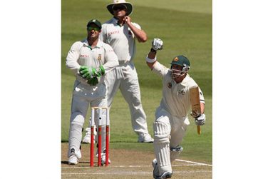 Phillip Hughes celebrates as he reaches  debut 100 through the leg side in Durban.
