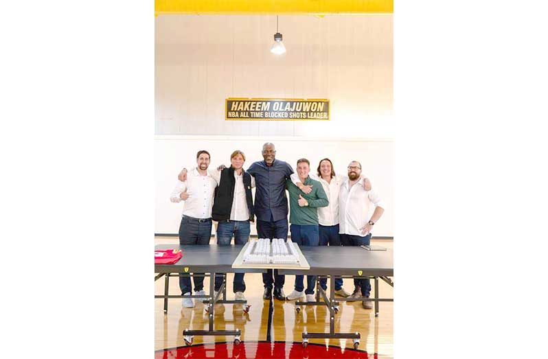NBA legend Hakeem Olajuwon (at centre) with the developers