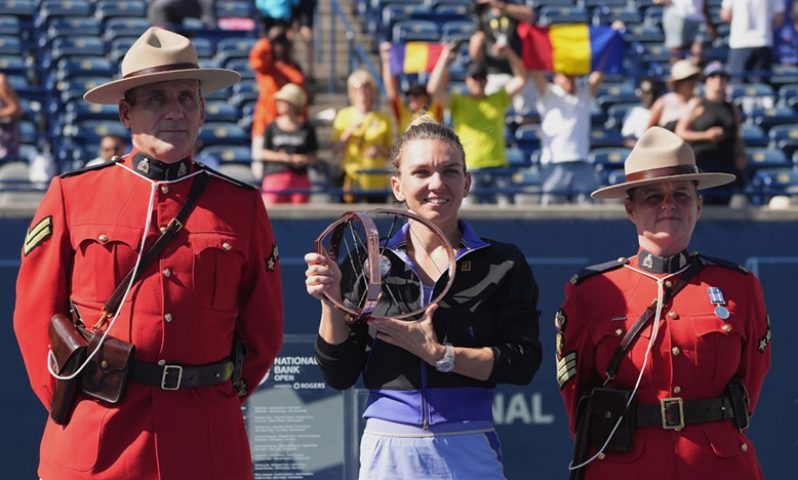 Simona Halep celebrates with her trophy