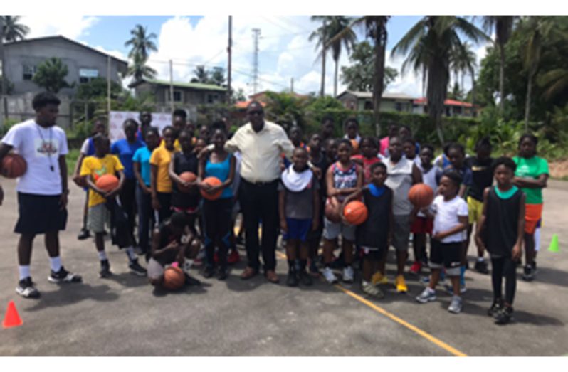Regional Chairman of Region 10, Deron Adams, is at centre with the boys and girls who are attending the camp this year