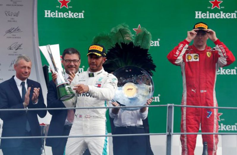 ormula One F1 - Italian Grand Prix - Circuit of Monza, Monza, Italy - September 2, 2018 Mercedes' Lewis Hamilton celebrates on the podium with the trophy after winning the race REUTERS/Stefano Rellandini