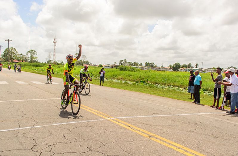 Hamza Eastman, is all jubilant as he crosses the finish line to win the second stage of the Forbes Burnham Memorial Cycle Road race yesterday