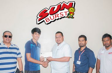 Avalon Jagnandan, Marketing and Sales Manager of Continental Group of Companies, hands over sponsorship cheque to National badminton champion Narayan Ramdhani in the presence of GBA president Mr Gokarn Ramdhani and Marketing representatives of the Sunburst Juice brand.