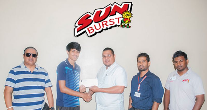 Avalon Jagnandan, Marketing and Sales Manager of Continental Group of Companies, hands over sponsorship cheque to National badminton champion Narayan Ramdhani in the presence of GBA president Mr Gokarn Ramdhani and Marketing representatives of the Sunburst Juice brand.
