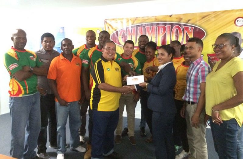 Executives of Edward B. Beharry hand over the cheque to the Green Machine.