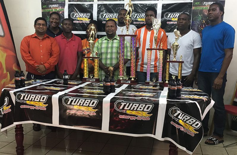 The various winners of the Turbo knockout football tournament collect their spoils yesterday at the GBI’s Diamond East Bank facility.