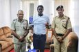 Captain of the Officers Cricket Team, Deputy Commissioner 'Administration', Mr Ravindradat Budhram (left) in his office at Eve Leary, along with Superintendent Ronald Alli, vice-captain of the Officers Cricket Team (right) flank Keon Boyce