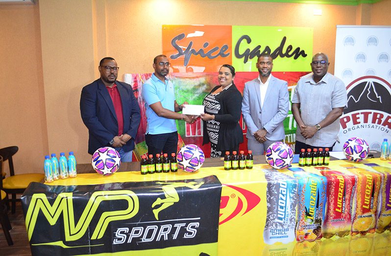 (from L-R) Director of the Petra Organisation, Troy Mendonca watches on as MVP Sports Proprietor, Ian Ramdeo presents a cheque to Nareesa Latiff.  Ansa McAl’s Errol Nelson and Director of Sport, Steve Ninvalle watch on.
