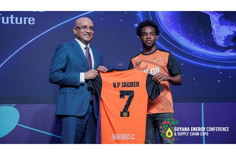 GFF Elite League 2024 season top scorer, Marcus Tudor, makes a presentation on behalf of Slingerz FC to Vice President, Bharrat Jagdeo