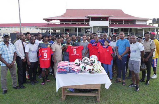 Officials of the GPF, and NYPD cricket team stand for a photo
