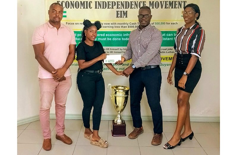 One of the members of EIM, Andrew Hercules (second right) handing over the donation to Mash Street Football Championship Ambassador Terryann Caesar yesterday, while Edison Jefford (left) and another share the moment