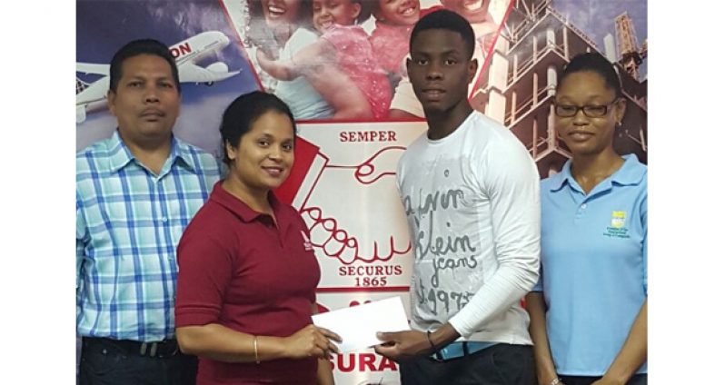 Hand-in-Hand employee Eshwarie Persaud (left), hands over sponsorship cheque to YWCC, Guyana and West Indies Youth batting sensation, Shimron Hetmyer, in the presence of Berbice Manager Tajpaul Adjhodea and another staff member of Hand-in-Hand.