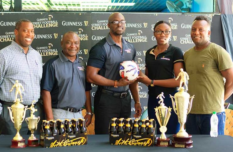 From L-R: Outdoor Events manager Mortimer Stewart stands with Banks PRO Troy Peters as Guinness Brand manager Lee Baptiste hands over a ball to Colors representative Prianna Damon in the presence of Referees coordinator Wayne Griffith.
