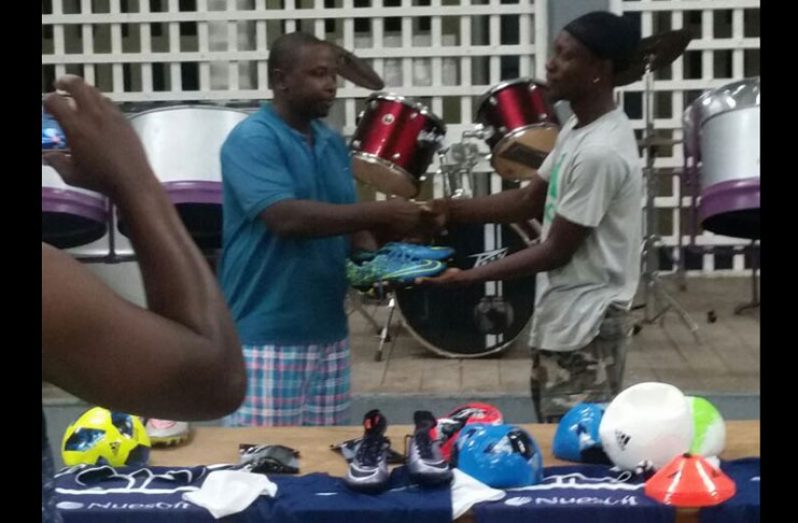 Pouderoyen Club treasurer Delroy Benjamin hands over the gear to vice-captain Cleveland Walcott.