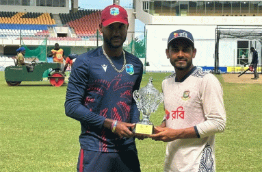 West Indies captain Kraigg Brathwaite (left) and Bangladesh captain, Mehidy Hasan Miraz pose with the winner’s trophy. (Photo courtesy CWI Media)