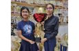 Amaya Sharma, left, hands over the winning female trophy to Laxhmi Ramnarine.