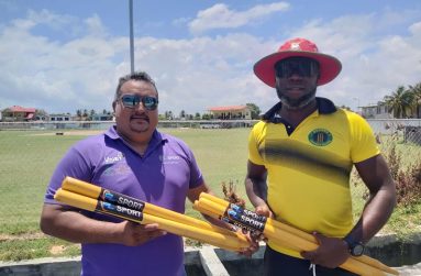 John Ramsingh (left) hands over the stumps to Jermain Maxwell of the Meten-Meer-Zorg Community Centre Cricket Club