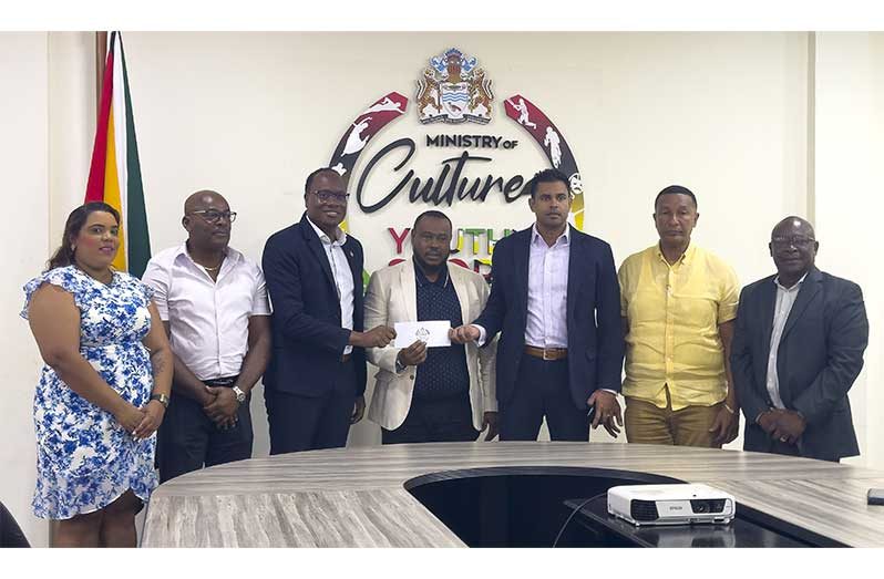 Ministers of MCYS presenting the cheque to Petra’s Troy Mendonca (Japhet Savory photo)