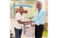 Businessman Lookeshwar 'Vick' Mahabeer (left) presents the sponsorship to Secretary of the DCB Davteerth Anandjit