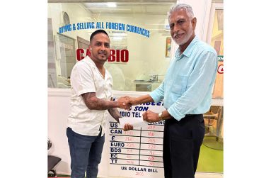 Businessman Lookeshwar 'Vick' Mahabeer (left) presents the sponsorship to Secretary of the DCB Davteerth Anandjit