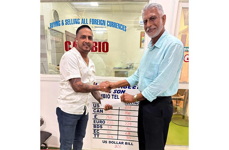 Businessman Lookeshwar 'Vick' Mahabeer (left) presents the sponsorship to Secretary of the DCB Davteerth Anandjit
