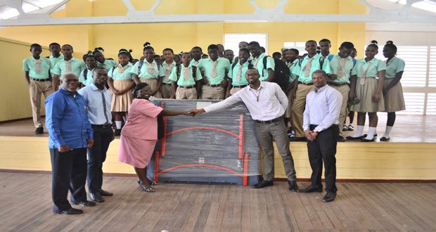 Flashback! Director of Sport Chris Jones hands over a table tennis board to the students of the Lodge Secondary School, in September, 2015.