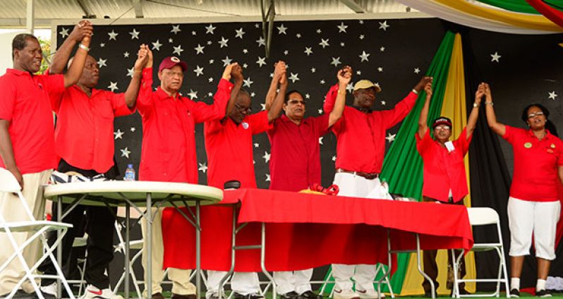 Representatives of the various trade union bodies hold hands on Sunday to depict unity within the movement. Acting President Moses Nagamootoo (fourth right) is seen holding hands with trade unionists
