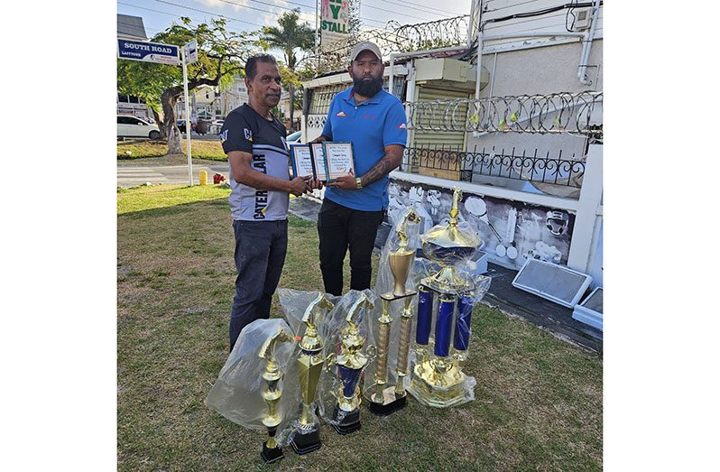 Victor Sunich, left, hands over the plaques to a representative of Jumbo Jet, organisers of the day’s events