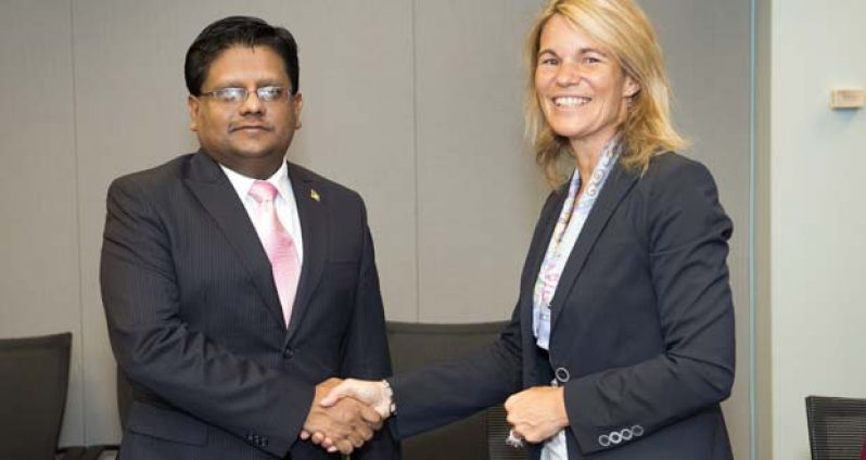 Guyana’s Minister of Finance,  Dr. Ashni Singh in a handshake with Sophie Sirtaine, Director of the Caribbean Country Management Unit of the World Bank after the signing of the agreements
