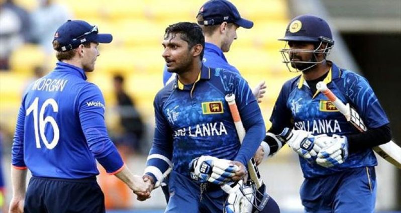 Sri Lanka's Kumar Sangakkara (2nd L) shakes hands with England's captain Eoin Morgan as Lahiru Thirimanne (R) shakes hands with Chris Woakes after their Cricket World Cup match in Wellington yesterday. (Reuters photo)