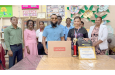 Safraz Haniff of Diversity Investment Inc hands over the prizes to Amanda Sampson while school officials and RHTYSC Cricketers look on
