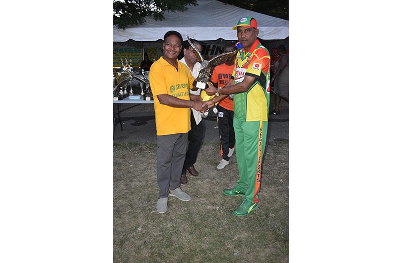 Regal Legends Captain Mahendra Hardyal (right) lifting the ‘Eagle’ - the symbol of supremacy in softball cricket in New York