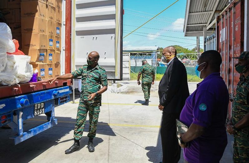 Director General of the Civil Defence Commission (CDC), Lieutenant Colonel Kester Craig briefing Director General of the Ministry of the Presidency, Joseph Harmon, on the items available for the social relief efforts.