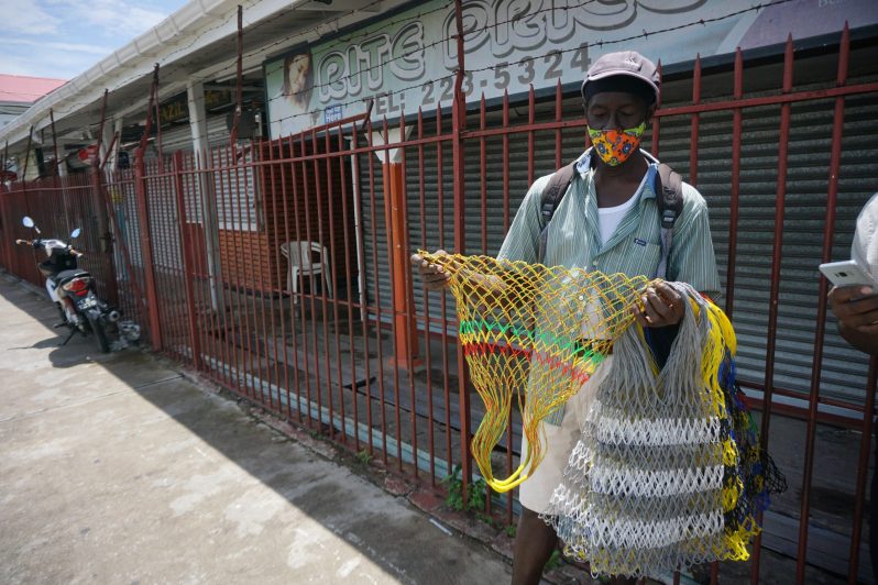 Raul Harmon with his handmade polythene bags. – Elvin Croker Photo.