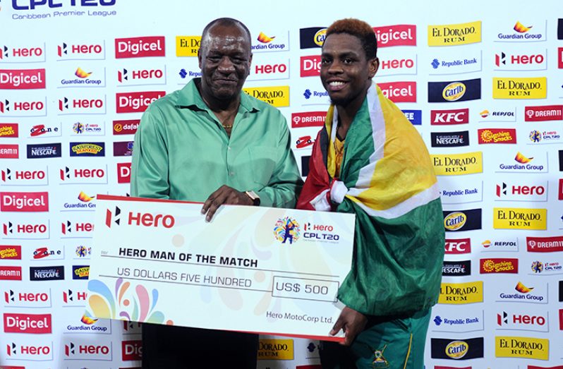 .      Shimron Hetmyer receives his man-of-the-match award from Minister of State Joseph Harmon