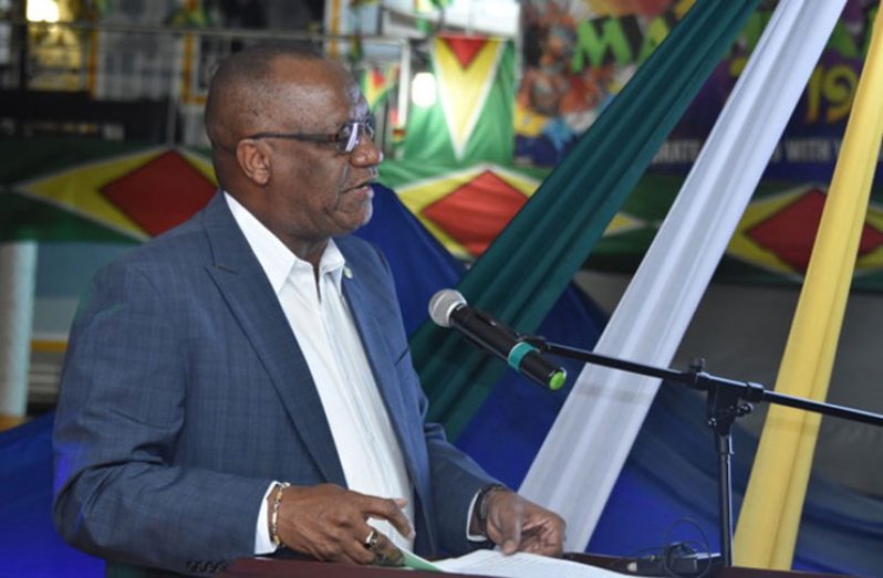 Minister of State Joseph Harmon delivering the feature address at the 49th Republic Anniversary flag-raising ceremony on Friday evening in Linden