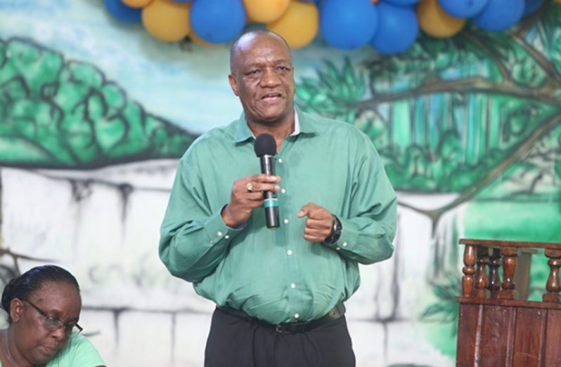 Minister of State Joseph Harmon addressing the audience